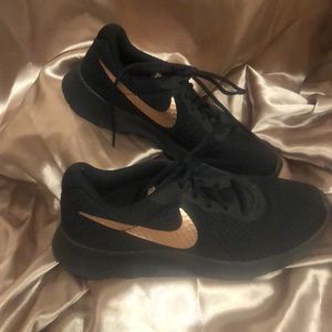 Black and rose gold Nike running shoe